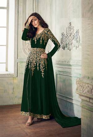 Add This Beautiful Designer To Your Wardrobe In Dark Green Color Paired With Dark Green Colored Bottom And Dupatta. Its Beautiful Embroidered Top Is Fabricated On Georgette Paired With Santoon Bottom And Chiffon Fabricated Dupatta. Its Rich Embroidery Pattern Is Giving The Suit An Attractive Look. 