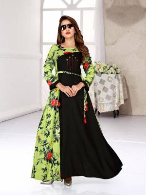 For Your Semi-Casuals, Grab This Readymade Gown In Black And Green Color Fabricated On Rayon. It Is Beautified With Bold Floral Prints And Available In All Regular Sizes. 