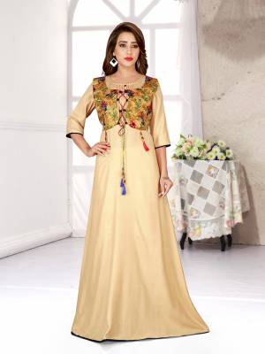 Celebrate This Festive Season With Beauty And Comfort Wearing This Designer Readymade Gown In Beige Color Fabricated On Rayon. 
