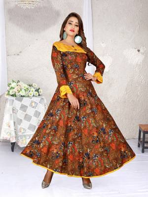 Look Pretty In This Designer Readymade Gown In Brown Color. This Gown Is Fabricated On Rayon Beautified With Abstract Prints All Over It. 
