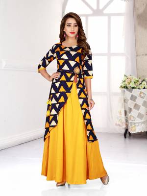 Celebrate This Festive Season With Beauty And Comfort Wearing This Designer Readymade Gown In Yellow And Navy Blue Color Fabricated On Rayon. 
