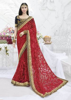 Adorn The Pretty Angelic Look Wearing This Heavy Designer Saree In Red Color Paired With Contrasting Navy Blue Colored Blouse. This Heavy Embroidered Saree Is Net Based Paired With Art Silk Fabricated Blouse. Buy Now.