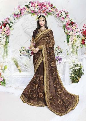Enhance Your Personality In This Heavy Designer Saree In Brown Color Paired With Brown Colored Blouse. This Saree Is Fabricated On Net Paired With Art Silk Fabricated Blouse. 