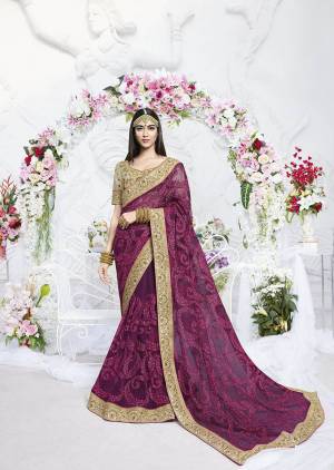 Look Attractive In This Heavy Designer Purple Colored Saree Paired With Beige Colored Blouse. This Saree Is Fabricated On Net Paired With Art Silk Fabricated Blouse. It Is Beautified With Heavy Tone To Tone Embroidery Over The Saree And Blouse. 