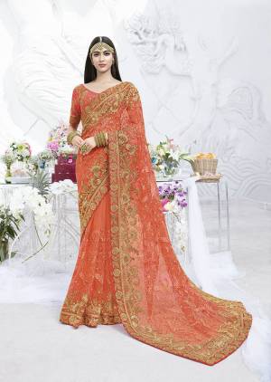 Bright And Visually Appealing Color Is Here With This Heavy Designer Saree In Orange Color Paired With Orange Colored Blouse. This Saree Is Fabricated On Net Paired With Art Silk Fabricated Blouse. This Heavy Saree IS Suitable For The Upcoming Wedding Season. 