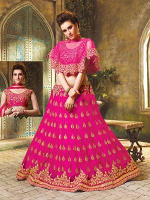 Here Is A Very Beautiful Cape Patterned Heavy Designer Lehenga Choli In All OverRani Pink Color. Its Blouse Is Fabricated On Art Silk Paired With Jacquard Net Lehenga And Chiffon Fabricated Dupatta. This Lehenga Choli Is Beautified With Heavy Embroidery And Its Lovely Pattern Will Earn You Lots Of Compliments From Onlookers. 