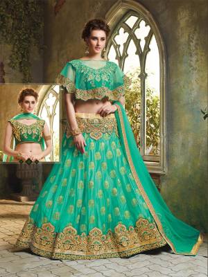 Here Is A Very Beautiful Cape Patterned Heavy Designer Lehenga Choli In All Over Sea Green Color. Its Blouse Is Fabricated On Art Silk Paired With Jacquard Net Lehenga And Chiffon Fabricated Dupatta. This Lehenga Choli Is Beautified With Heavy Embroidery And Its Lovely Pattern Will Earn You Lots Of Compliments From Onlookers. 