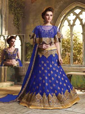 Here Is A Very Beautiful Cape Patterned Heavy Designer Lehenga Choli In All Over Royal Blue Color. Its Blouse Is Fabricated On Art Silk Paired With Jacquard Net Lehenga And Chiffon Fabricated Dupatta. This Lehenga Choli Is Beautified With Heavy Embroidery And Its Lovely Pattern Will Earn You Lots Of Compliments From Onlookers. 