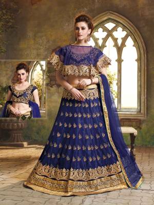 Here Is A Very Beautiful Cape Patterned Heavy Designer Lehenga Choli In All Over Navy Blue Color. Its Blouse Is Fabricated On Art Silk Paired With Jacquard Net Lehenga And Chiffon Fabricated Dupatta. This Lehenga Choli Is Beautified With Heavy Embroidery And Its Lovely Pattern Will Earn You Lots Of Compliments From Onlookers. 