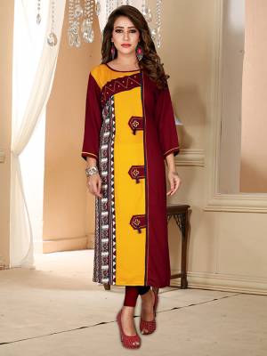 For Your Semi-Casuals, Grab This Simple Readymade Kurti In Maroon And Yellow Color Fabricated On Rayon. 