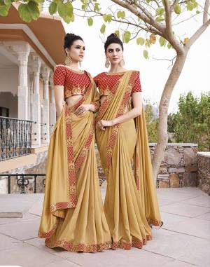 Celebrate This Festive Season With Beauty And Comfort Wearing This Rich Looking Designer Saree In Occur Yellow Color Paired With contrasting Red Colored Blouse, This Saree IS Fabricated on soft Silk paired With Art Silk Fabricated Blouse. 
