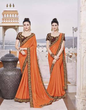 Adorn A Beautiful Traditional Look Wearing This Designer Saree In Orange Color Paired With Contrasting Brown Colored Blouse. This Saree And Blouse are Silk bAsed Which Also Gives A Rich Look To Your Personality. 