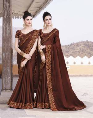 You Will Definitely Earn lots of Compliments Wearing This Rich And Elegant Looking Designer Saree In Brown Color Paired With Brown Colored Blouse. This Saree And Blouse are Silk based Beautified With Pretty Tone To Tone Work. 