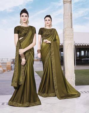 New Shade Is Here To Add Into Your Wardrobe With This Designer Saree In Olive Green Color Paired With Olive Green Colored Blouse. This Saree Is Fabricated On Satin Silk Paired With Art Silk Fabricated Blouse. Its Rich Fabric And Color Will Give An Elegant Look To Your Personality. 