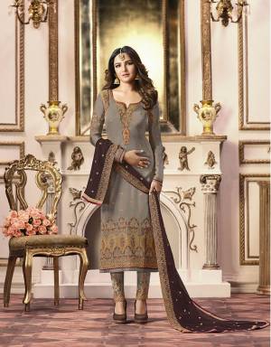 Flaunt Your Rich And Elegant Taste Wearing This Heavy Designer Straight Suit In Grey Color Paired With Contrasting Dark Brown Colored Dupatta. Its Top Is Fabricated On Satin Georgette Paired With Santoon Bottom And Georgette Fabricated Dupatta. 