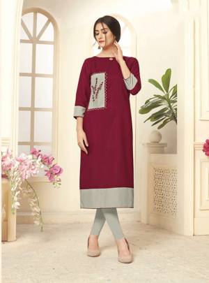 Grab This Pretty Maroon Colored Readymade Kurti Fabricated On Cotton Slub. It Is Beautified With Contrasting Patch With Thread Work. You Can Pair This Up With Same or Contrasting Colored Leggings. 