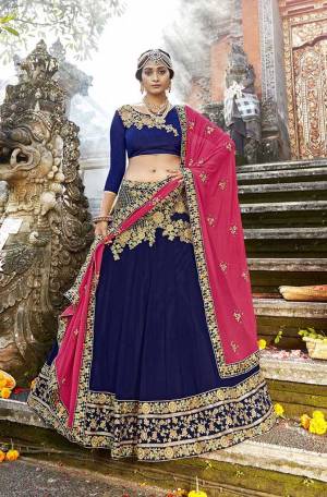 Bright And Visually Appealing Color Pallete Is Here With This Heavy Designer Lehenga Choli In Royal Blue Color Paired With Contrasting Dark Pink Colored Dupatta. Its Blouse Is Fabricated On Art Silk Paired With Georgette Fabricated Lehenga And Chiffon Dupatta. Its Bright Colors And Attractive Embroidery Will Give You A Look Like Never Before. 