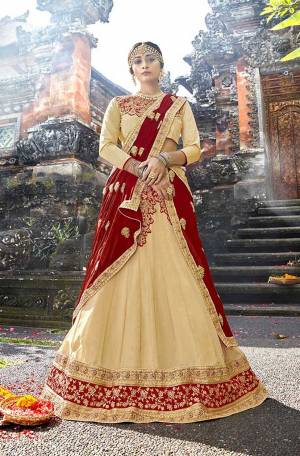 Here Is An Evergreen Color Pallete With This Heavy Designer Lehenga Choli In Cream Color Paired With Contrasting Red Colored Dupatta. Its Blouse Is Fabricated On Art Silk Paired With Georgette Fabricated Lehenga And Chiffon Dupatta. 