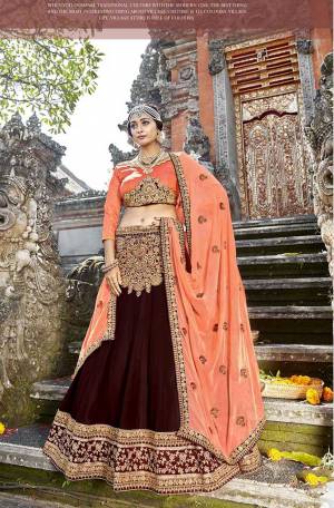 Rich And Elegant Looking Heavy Designer Lehenga Choli Is Here In Orange Colored Blouse Paired With Brown Colored Lehenga And Orange Colored Dupatta. Its Blouse Is Fabricated on Art Silk Paired With Georgette Fabricated Lehenga And Chiffon Fabricated Dupatta. 