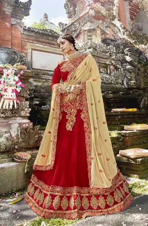 Here Is An Evergreen Color Pallete With This Heavy Designer Lehenga Choli In Red Color Paired With Contrasting Cream Colored Dupatta. Its Blouse Is Fabricated On Art Silk Paired With Georgette Fabricated Lehenga And Chiffon Dupatta. 