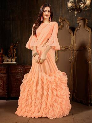 Add This Beautiful Designer Ruffled Saree To Your Wardrobe In Peach Color For The Upcoming Festive And Wedding Season. This Trendy Saree Is Fabricated On Georgette Paired With Art Silk And Georgette Fabricated Blouse. Its Trendy Pattern And Pretty Color Will EArn You Lots Of Compliments From Onlookers. 