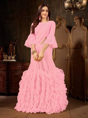 Add This Beautiful Designer Ruffled Saree To Your Wardrobe In Pink Color For The Upcoming Festive And Wedding Season. This Trendy Saree Is Fabricated On Georgette Paired With Art Silk And Georgette Fabricated Blouse. Its Trendy Pattern And Pretty Color Will EArn You Lots Of Compliments From Onlookers. 