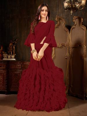 Add This Beautiful Designer Ruffled Saree To Your Wardrobe In Maroon Color For The Upcoming Festive And Wedding Season. This Trendy Saree Is Fabricated On Georgette Paired With Art Silk And Georgette Fabricated Blouse. Its Trendy Pattern And Pretty Color Will EArn You Lots Of Compliments From Onlookers. 