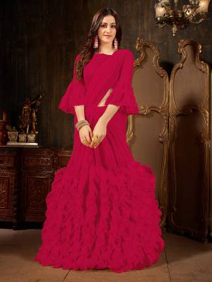 Add This Beautiful Designer Ruffled Saree To Your Wardrobe In Magenta Pink Color For The Upcoming Festive And Wedding Season. This Trendy Saree Is Fabricated On Georgette Paired With Art Silk And Georgette Fabricated Blouse. Its Trendy Pattern And Pretty Color Will EArn You Lots Of Compliments From Onlookers. 