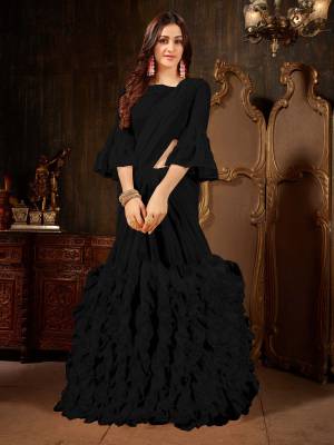 Add This Beautiful Designer Ruffled Saree To Your Wardrobe In Black Color For The Upcoming Festive And Wedding Season. This Trendy Saree Is Fabricated On Georgette Paired With Art Silk And Georgette Fabricated Blouse. Its Trendy Pattern And Pretty Color Will EArn You Lots Of Compliments From Onlookers. 