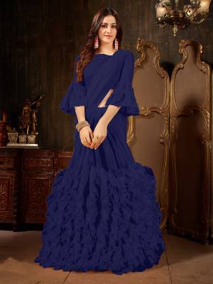Add This Beautiful Designer Ruffled Saree To Your Wardrobe In Navy Blue Color For The Upcoming Festive And Wedding Season. This Trendy Saree Is Fabricated On Georgette Paired With Art Silk And Georgette Fabricated Blouse. Its Trendy Pattern And Pretty Color Will EArn You Lots Of Compliments From Onlookers. 