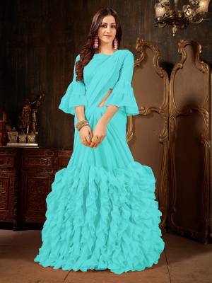 Add This Beautiful Designer Ruffled Saree To Your Wardrobe In Sky Blue Color For The Upcoming Festive And Wedding Season. This Trendy Saree Is Fabricated On Georgette Paired With Art Silk And Georgette Fabricated Blouse. Its Trendy Pattern And Pretty Color Will EArn You Lots Of Compliments From Onlookers. 