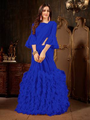 Add This Beautiful Designer Ruffled Saree To Your Wardrobe In Royal Blue Color For The Upcoming Festive And Wedding Season. This Trendy Saree Is Fabricated On Georgette Paired With Art Silk And Georgette Fabricated Blouse. Its Trendy Pattern And Pretty Color Will EArn You Lots Of Compliments From Onlookers. 