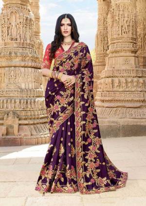 Bright And Visually Appealing Color Pallete Is Here With This Heavy Designer Saree In Purple Color Paired With Contrasting Pink Colored Blouse. This Saree And Blouse Are Silk Based Beautified With Heavy Embroidery. 