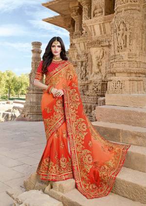 Celebrate This Festive Season With A Proper Traditional Look Wearing This Heavy Designer Saree In Ethnic Color Pallete With Orange Color Paired With Contrasting Red Colored Blouse. This Heavy Embroidered Saree Is Georgette Based Paired With Art Silk Fabricated Blouse. 