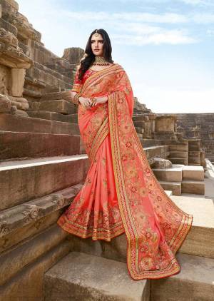 Look Pretty In This Heavy Designer Saree In Dark Peach Color Paired With Contrasting Red Colored Blouse. This Saree Is Silk Georgette Based Paired With Art silk Fabricated Blouse. Buy This Designer Saree Now.
