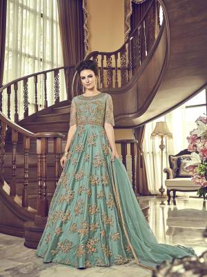 Grab This Beautiful Heavy Designer Floor Length Suit In Turquoise Blue Color. Its Heavy Embroidered Top IS Fabricated On Net Paired With Santoon Bottom And Net Fabricated Dupatta. Buy This Semi-Stitched Suit.