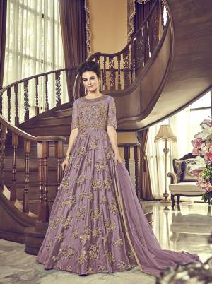 Grab This Beautiful Heavy Designer Floor Length Suit In Lilac Color. Its Heavy Embroidered Top IS Fabricated On Net Paired With Santoon Bottom And Net Fabricated Dupatta. Buy This Semi-Stitched Suit.