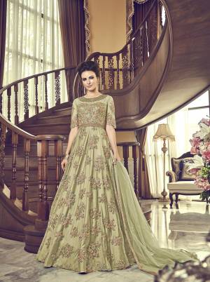 Grab This Beautiful Heavy Designer Floor Length Suit In Pastel Green Color. Its Heavy Embroidered Top IS Fabricated On Net Paired With Santoon Bottom And Net Fabricated Dupatta. Buy This Semi-Stitched Suit.