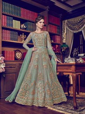 Look Pretty Wearing This Designer Floor Length Suit In Aqua Blue Color Paired With Aqua Blue Colored Bottom And Dupatta. Its Top Is Fabricated On Net Paired With Santoon Bottom And Net Fabricated Dupatta. 