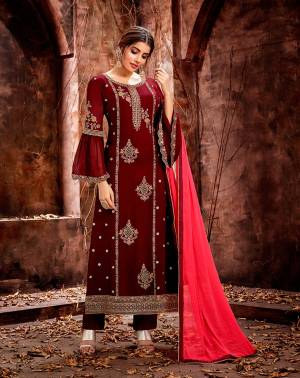 Here Is A Royal Looking Designer Straight Suit In Maroon Color Paired With Contrasting Fuschia Pink Colored Dupatta. Its Heavy Embroidered Top Is Fabricated On Georgette Paired With Santoon Bottom And Chiffon Fabricated Dupatta. 