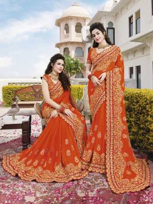 For A Proper Traditional Look, Grab This Very Beautiful Heavy Designer Saree In Orange Color Paired With Orange Colored Blouse. This Saree Is Silk Georgette Based Paired With Art Silk Fabricated Blouse. 