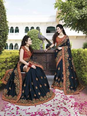 Get Ready For The Upcoming Festive and Wedding Season With This Heavy Designer Saree In Prussian Blue Color Paired With Contrasting Red Colored Blouse. This Saree And Blouse are Silk Based Also Give A Rich Look To Your personality. 