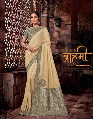 The soft beige is a heavenly hue.The golden weaves within the saree with just the perfect touch of handwork makes this piece irresistible. 