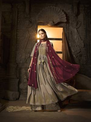 New And Unique Shade Is Here To Add Into Your Wardrobe With This Designer Suit In Sand Grey Color Paired With Contrasting Maroon Colored Dupatta. Its Top And Bottom Are Fabricated On Muslin Paired With Chiffon Fabricated Dupatta. It Is Beautified With Attractive Foil Print and Embroidery. 