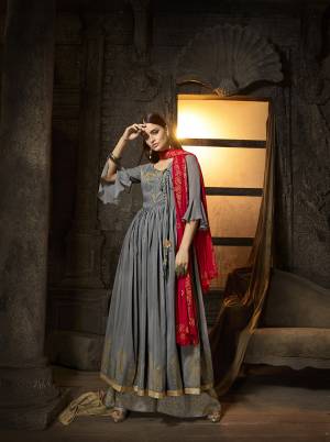 Rich and Elegant Looking Designer Indo-Western Suit Is Here In Steel Grey Color Paired With Contrasting Red Colored Dupatta. Its Very Pretty Flaired Top And Plazzo Are Fabricated On Muslin Paired With Chiffon Fabricated Dupatta. Its Rich Color Pallete And Fabric Will Earn You Lots Of Compliments From Onlookers. 