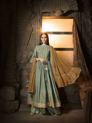 You Will Definitely Earn Lots Of Compliments Wearing This Designer Plazzo Flair Suit In Steel Blue Colored Top And Bottom Paired With Contrasting Light Brown Colored Dupatta. Its Top And Bottom Are Fabricated On Muslin Paired With Chiffon Fabricated Dupatta. Buy Now.