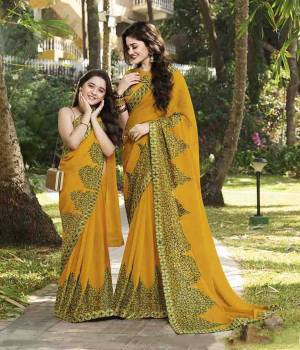 Celebrate This Festive Season with Beauty And Comfort Wearing This Designer Chiffon Based Saree In Musturd Yellow Color Paired With Musturd Yellow Colored Blouse. It Has Attractive And Heavy Embroidered Lace Border. 