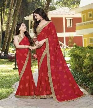 Add This Very pretty Saree To Your Wardrobe For The Upcoming Festive Season In Red Color Paired With Beige Colored Blouse. This Heavy Embroidered Saree Is Chiffon Based Paired With Art Silk Fabricated Blouse. 
