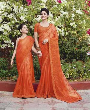 Celebrate This Festive Season with Beauty And Comfort Wearing This Designer Silk Georgette Based Saree In Orange Color Paired With Orange Colored Blouse. It Has Attractive And Heavy Embroidered Lace Border. 