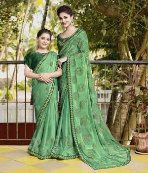 Get Ready For The Upcoming Festive Season With This Beautiful Designer Saree In Light Green Color Paired With Green Colored Blouse. This Saree Is Fabricated On Chiffon Paired With Art Silk Fabricated Blouse. It Is Beautified With Embroidered Lace Border And Butti.